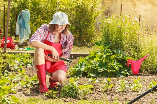 Gardener preparing a quote in Mitcham front garden